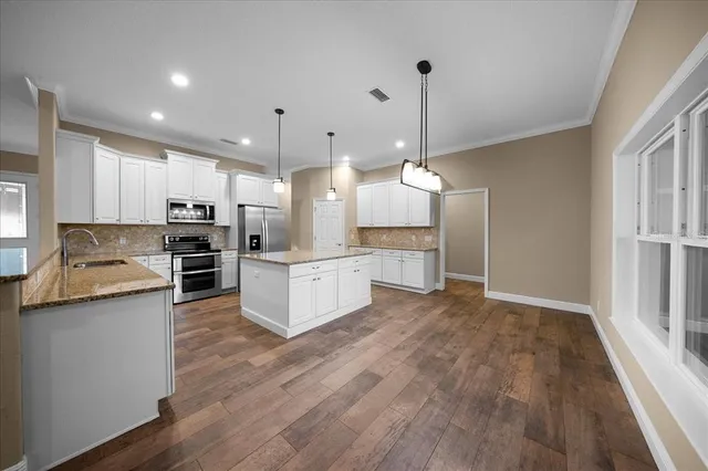 a view of a room with wooden floor and window