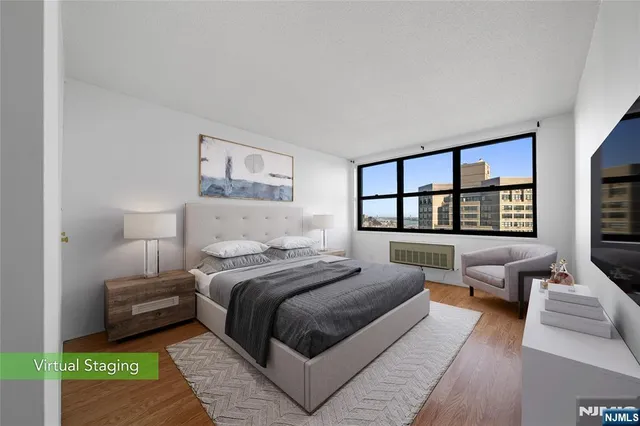 a bedroom with a bed a couch and a large window