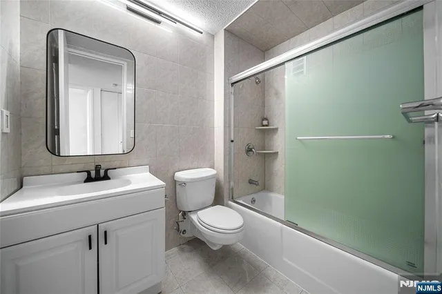 a bathroom with a toilet a sink and shower