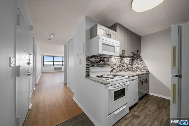 a kitchen with stainless steel appliances a stove and a refrigerator