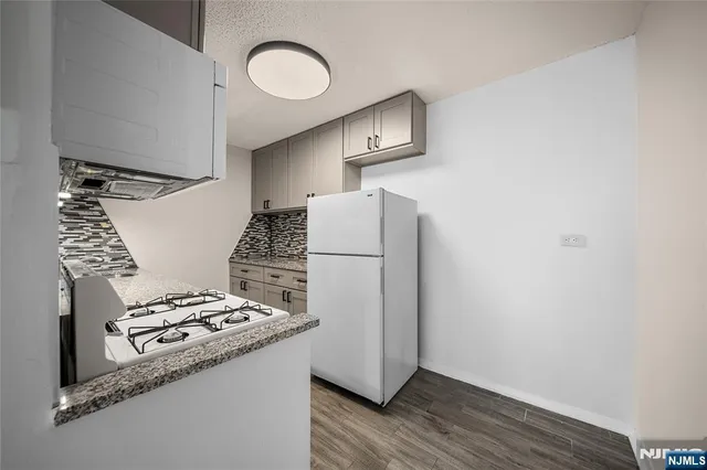 a kitchen with a refrigerator and a stove