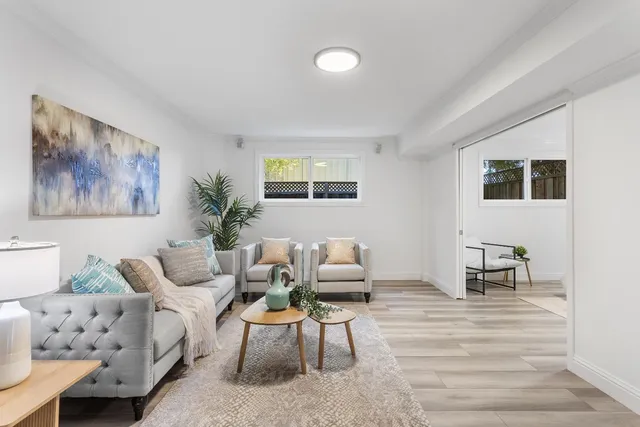 a living room with furniture and painting on the wall