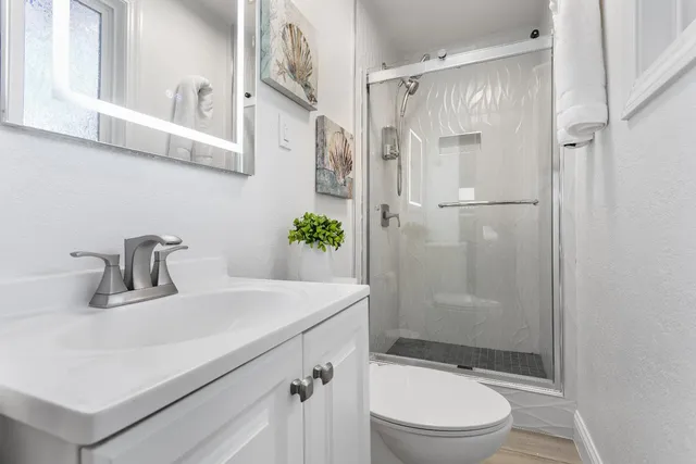 a bedroom with a bed and a painting on the wall