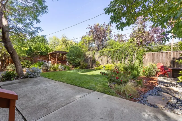 a view of a chair and table in the backyard
