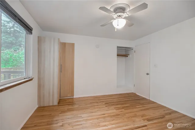 a view of a room with a ceiling fan and a window