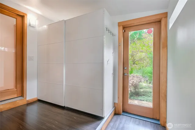 an empty room with wooden floor and a window