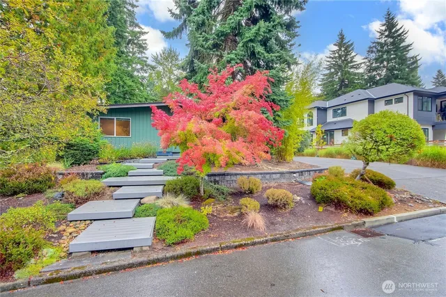 a front view of a house with a yard and a garage