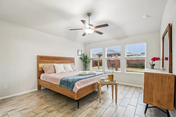 a bedroom with a bed and glass window