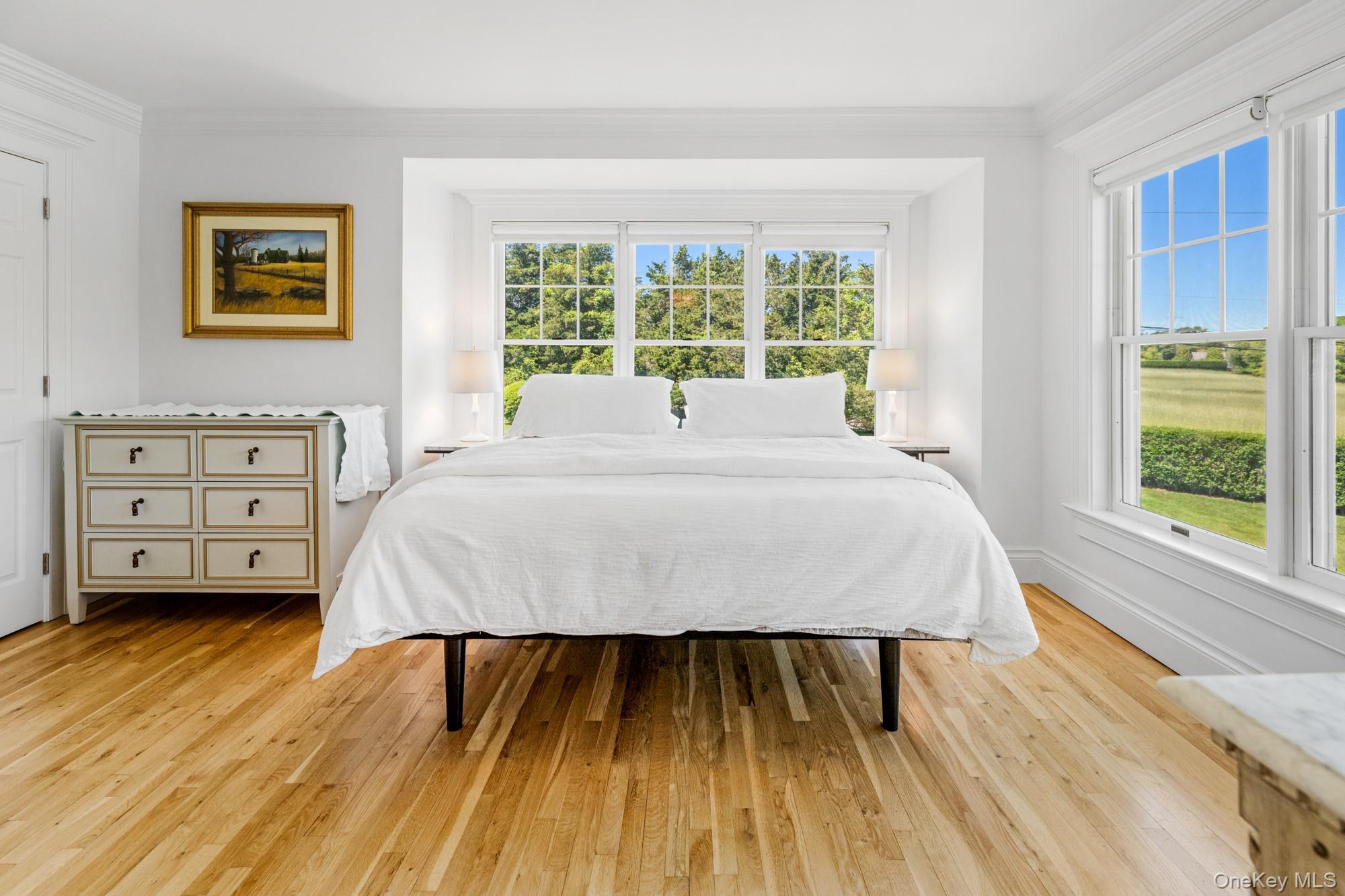 5 Lower 7 Ponds Road Water Mill, NY 11976 - Photo 19 of 35 Bedroom featuring light wood finished floors, ornamental molding, and baseboards