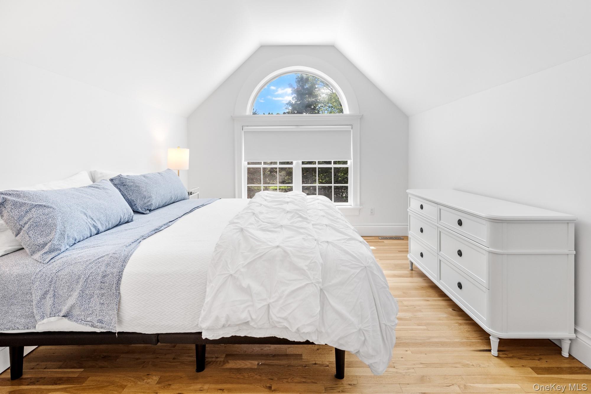 5 Lower 7 Ponds Road Water Mill, NY 11976 - Photo 21 of 35 Bedroom with lofted ceiling and light wood-style flooring