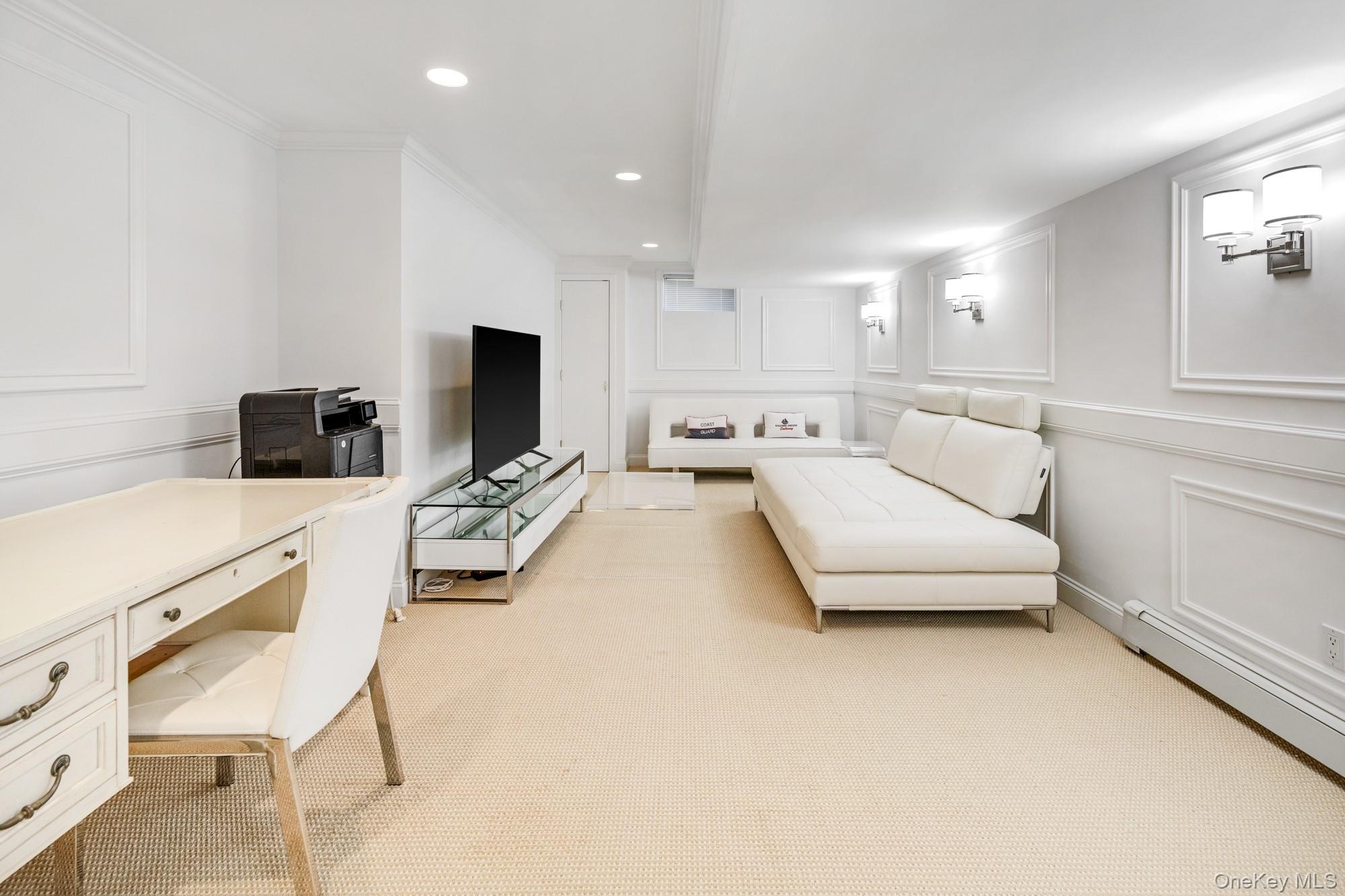 5 Lower 7 Ponds Road Water Mill, NY 11976 - Photo 25 of 35 Living area with a decorative wall, a baseboard heating unit, light carpet, an office area, and recessed lighting