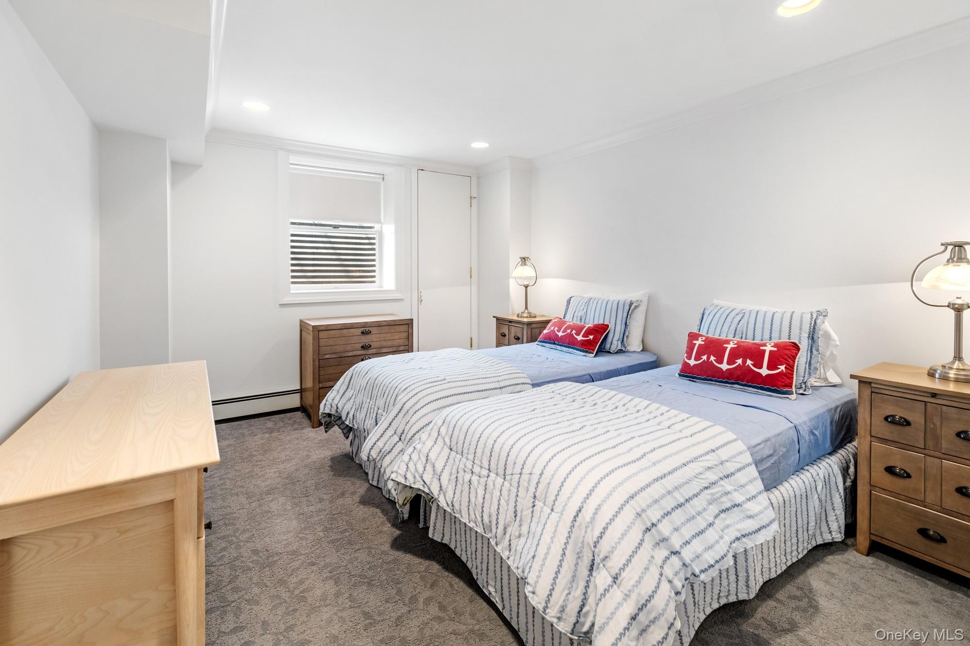 5 Lower 7 Ponds Road Water Mill, NY 11976 - Photo 26 of 35 Bedroom featuring carpet floors, a baseboard radiator, ornamental molding, and recessed lighting