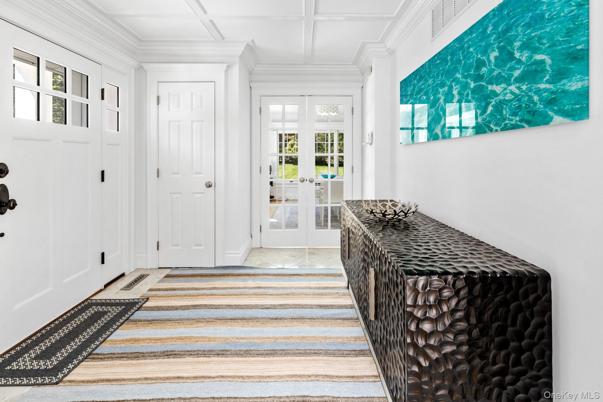 5 Lower 7 Ponds Road Water Mill, NY 11976 - Photo 4 of 35 Entrance foyer with french doors, plenty of natural light, coffered ceiling, crown molding, and beam ceiling