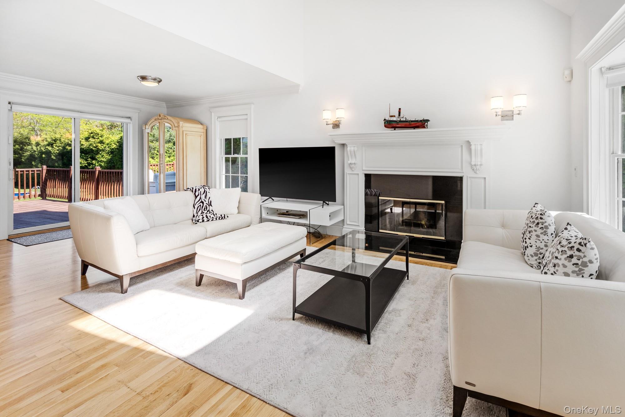 5 Lower 7 Ponds Road Water Mill, NY 11976 - Photo 9 of 35 Living room with wood finished floors and a fireplace with flush hearth