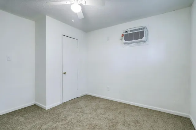 an empty room with a ceiling fan