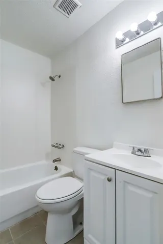 a bathroom with a sink a toilet and a bathtub