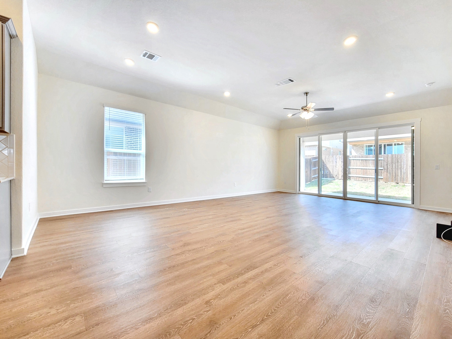 2329 Gabriels Horn Road Leander, TX 78641 - Photo 6 of 23 A spacious living area features rich hardwood flooring and large glass doors opening to a private yard.