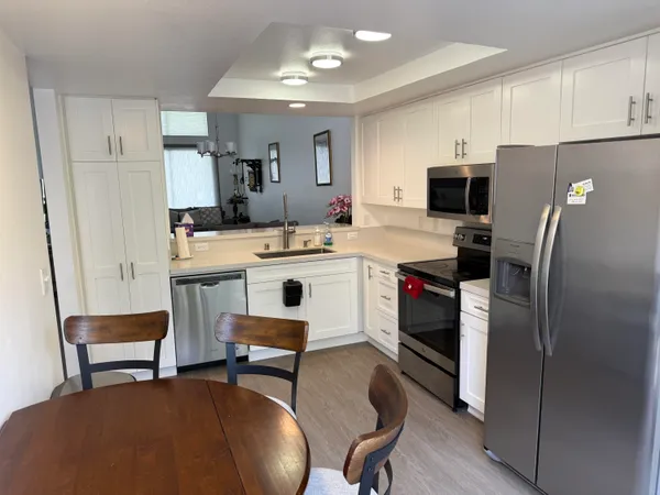a kitchen with stainless steel appliances a stove a microwave and a sink