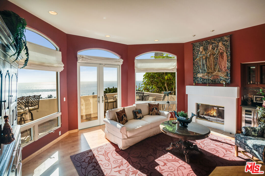 1643 La Vista Del Oceano Santa Barbara, CA 93109 - Photo 12 of 36 a living room with furniture fireplace and a large window