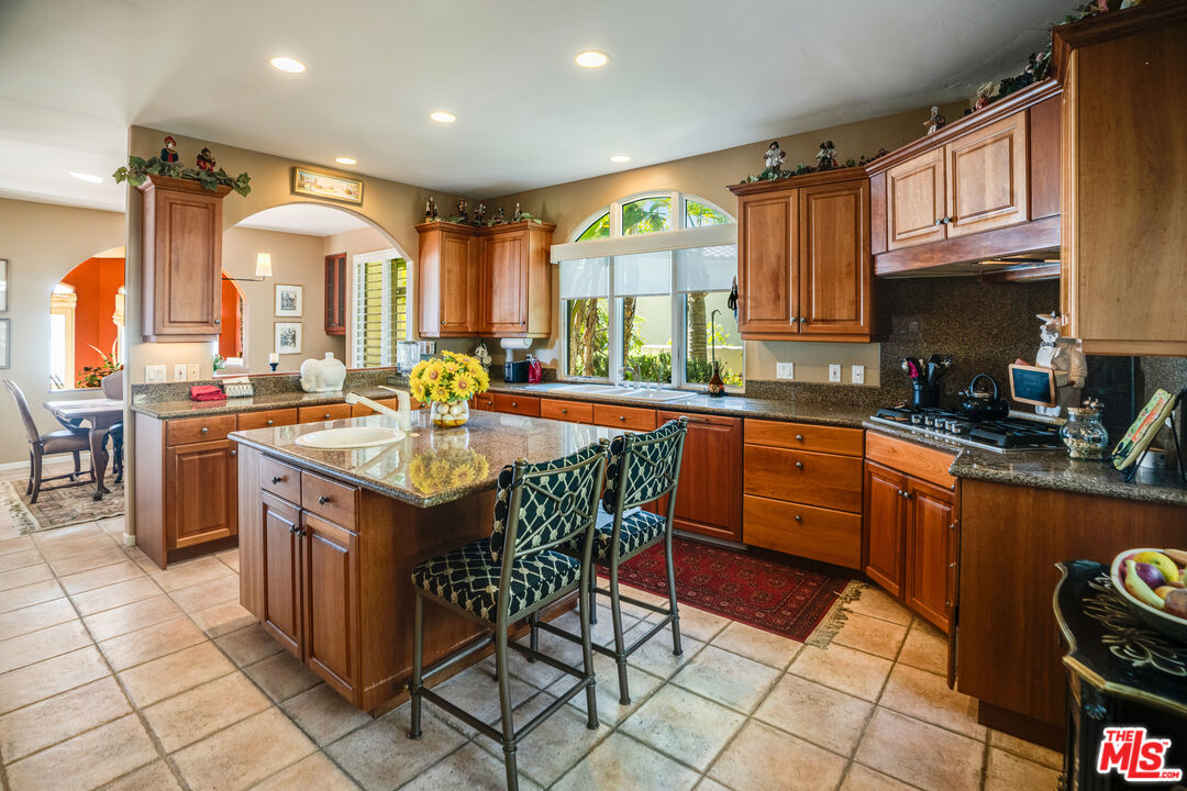 1643 La Vista Del Oceano Santa Barbara, CA 93109 - Photo 19 of 36 a kitchen with stainless steel appliances granite countertop a stove a sink and a refrigerator