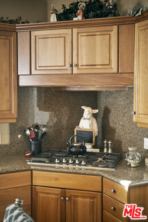 1643 La Vista Del Oceano Santa Barbara, CA 93109 - Photo 20 of 36 a kitchen with a stove and cabinets