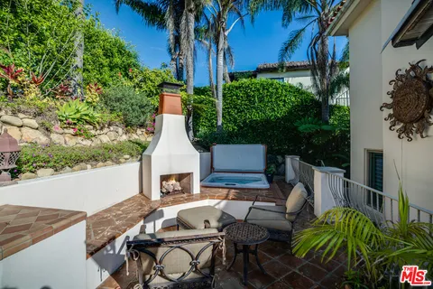 a view of backyard of house with seating space