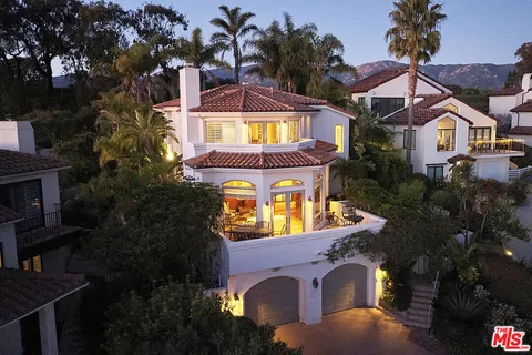 aerial view of a house with a swimming pool and a yard