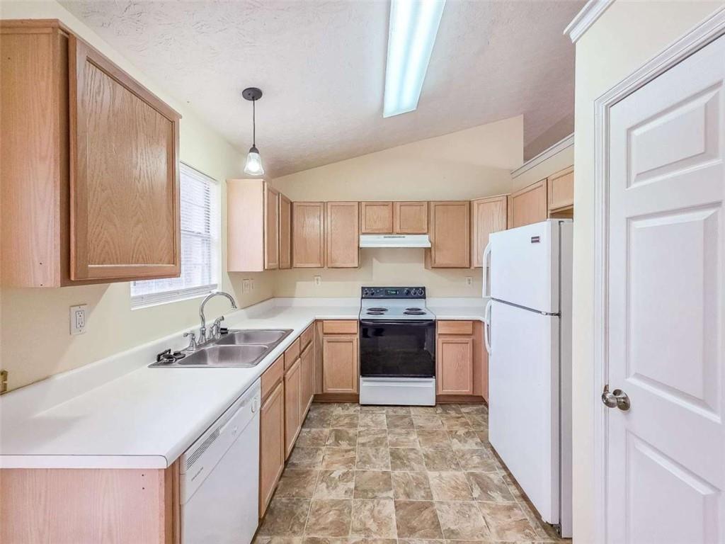 2276 Ramblewood Circle Decatur, GA 30035 - Photo 13 of 34 a kitchen with a refrigerator sink and wooden cabinets