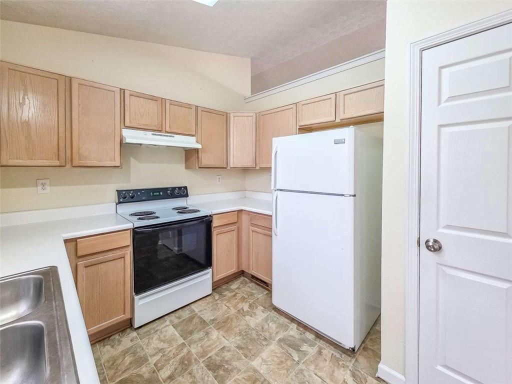 2276 Ramblewood Circle Decatur, GA 30035 - Photo 15 of 34 a kitchen with a refrigerator sink stove and cabinets