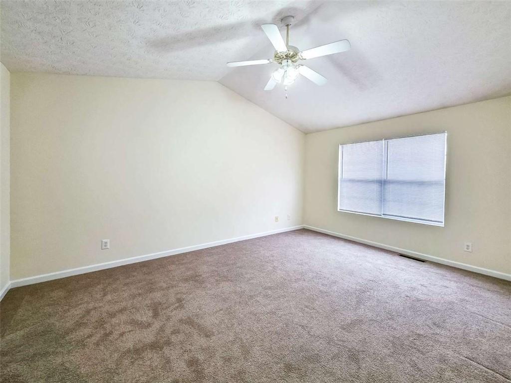 2276 Ramblewood Circle Decatur, GA 30035 - Photo 19 of 34 an empty room with chandelier fan and windows