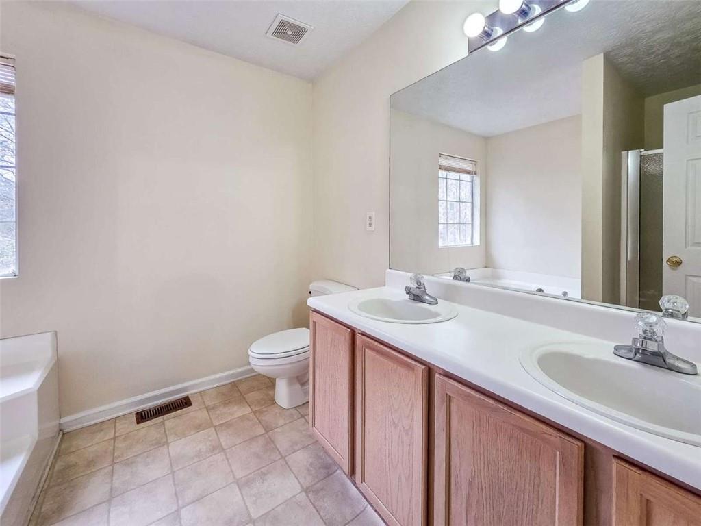 2276 Ramblewood Circle Decatur, GA 30035 - Photo 23 of 34 a bathroom with a sink a toilet and mirror