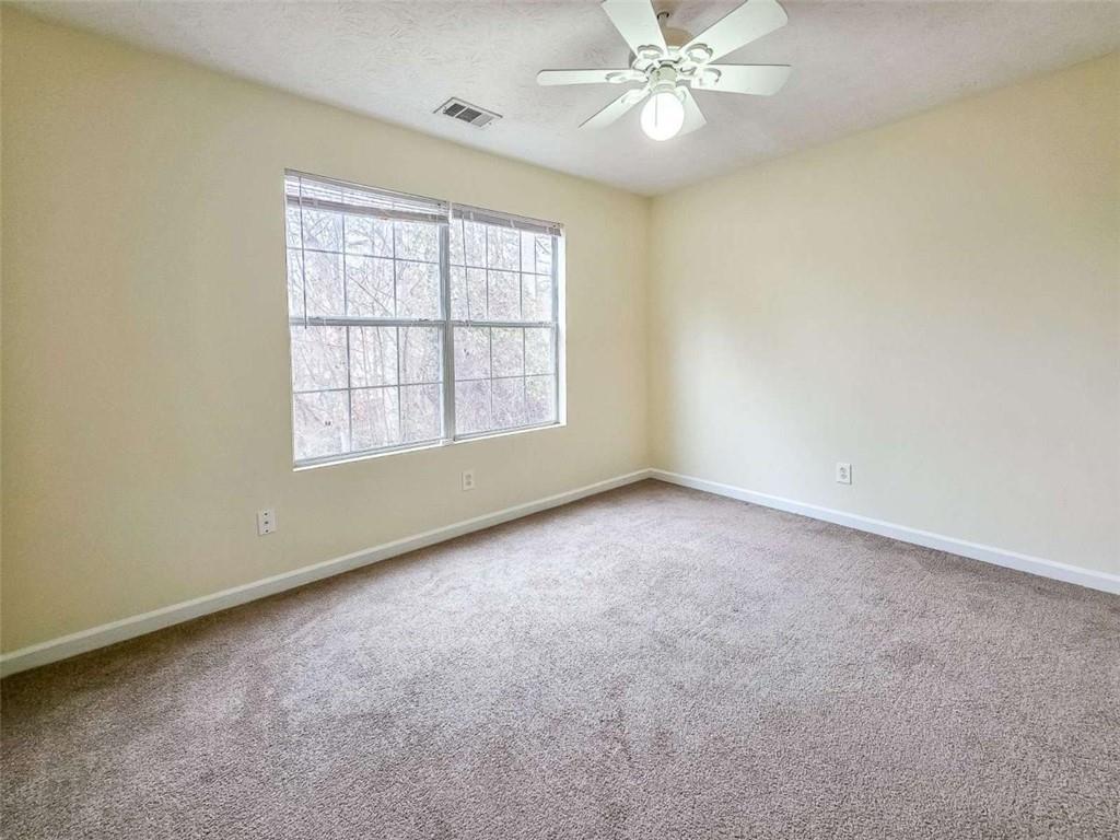 2276 Ramblewood Circle Decatur, GA 30035 - Photo 28 of 34 an empty room with chandelier fan and windows
