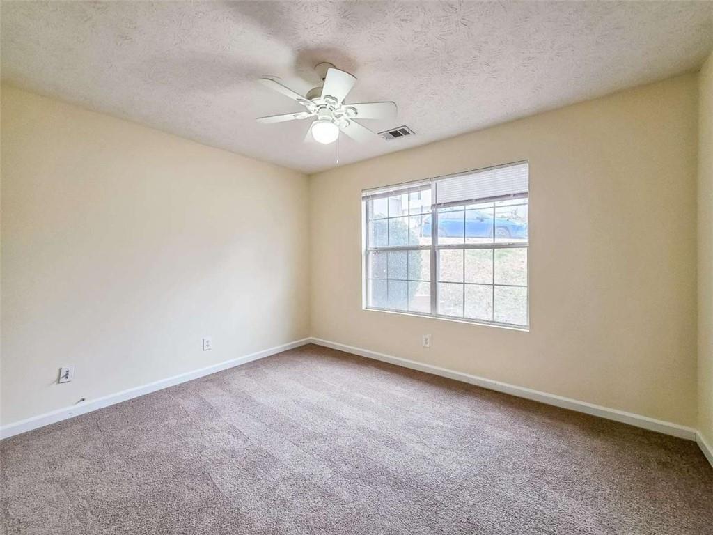 2276 Ramblewood Circle Decatur, GA 30035 - Photo 29 of 34 an empty room with chandelier fan and windows