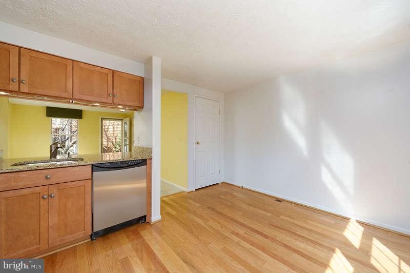 1949 Belmont Ridge Court Reston, VA 20191 - Photo 5 of 23 a kitchen with stainless steel appliances granite countertop a sink and cabinets with wooden floor