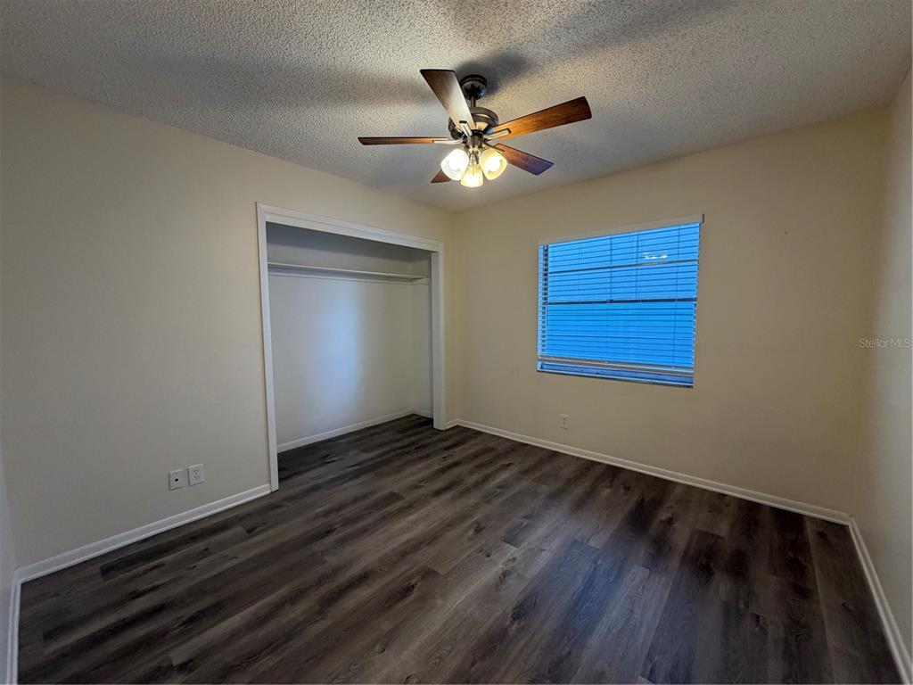 1740 West Walnut Street Tampa, FL 33607 - Photo 13 of 28 a view of an empty room with wooden floor and a window