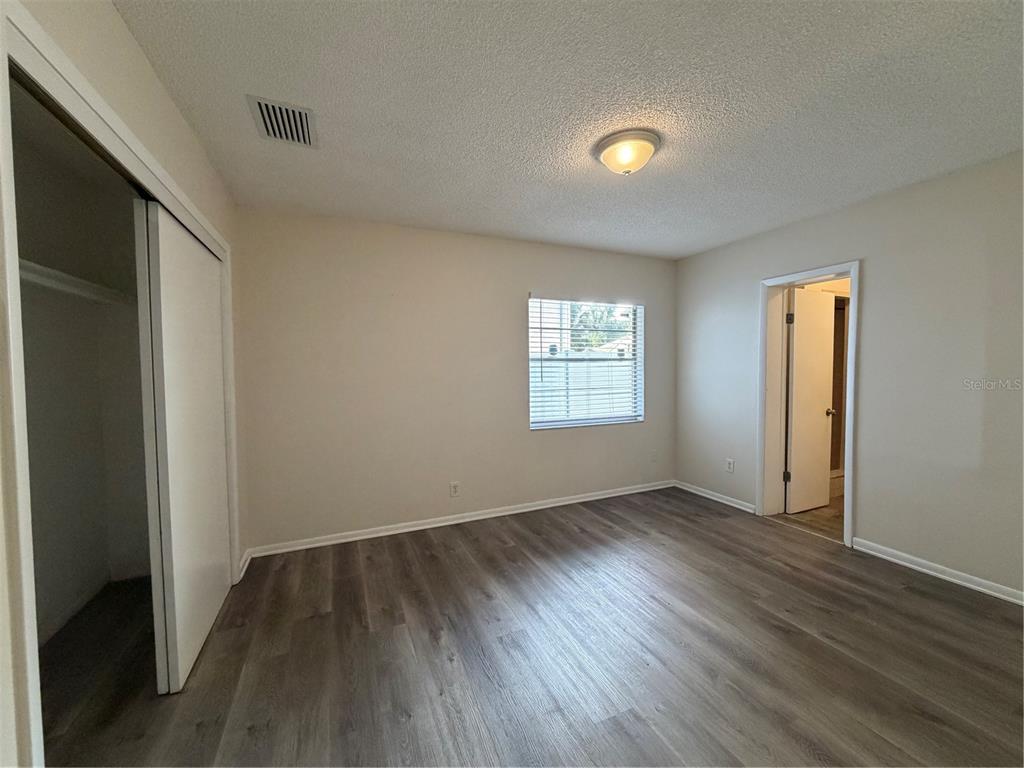 1740 West Walnut Street Tampa, FL 33607 - Photo 17 of 28 an empty room with wooden floor and windows