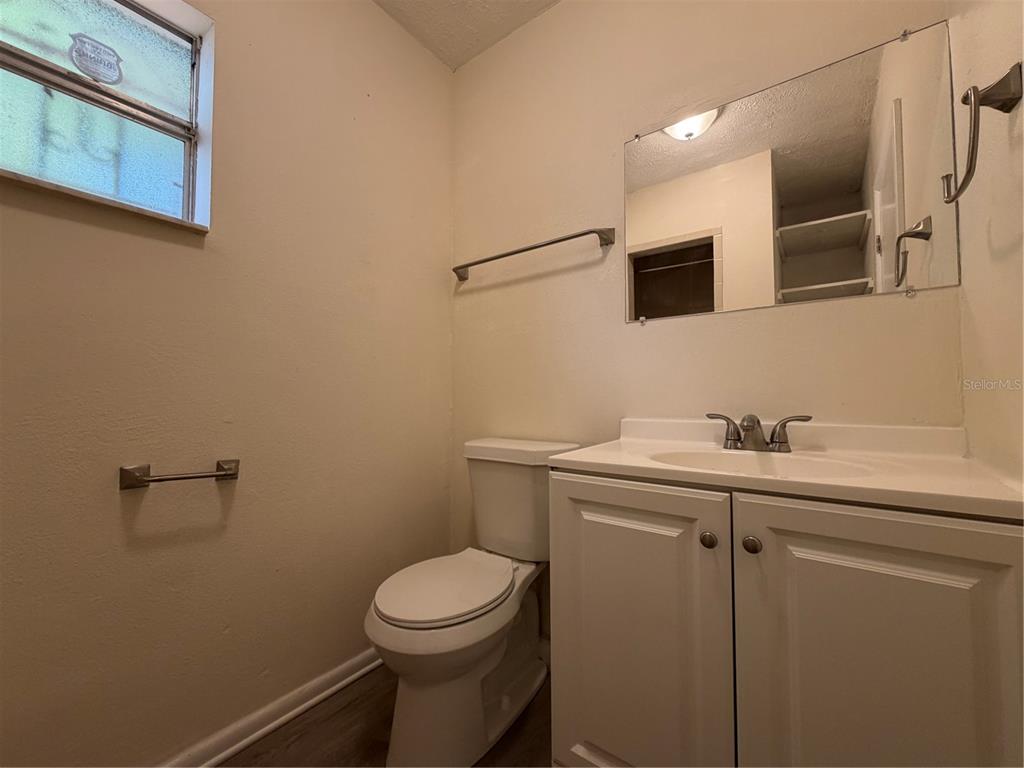 1740 West Walnut Street Tampa, FL 33607 - Photo 20 of 28 a bathroom with a sink a toilet and mirror