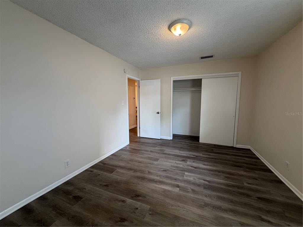 1740 West Walnut Street Tampa, FL 33607 - Photo 21 of 28 a view of an empty room with wooden floor and a window