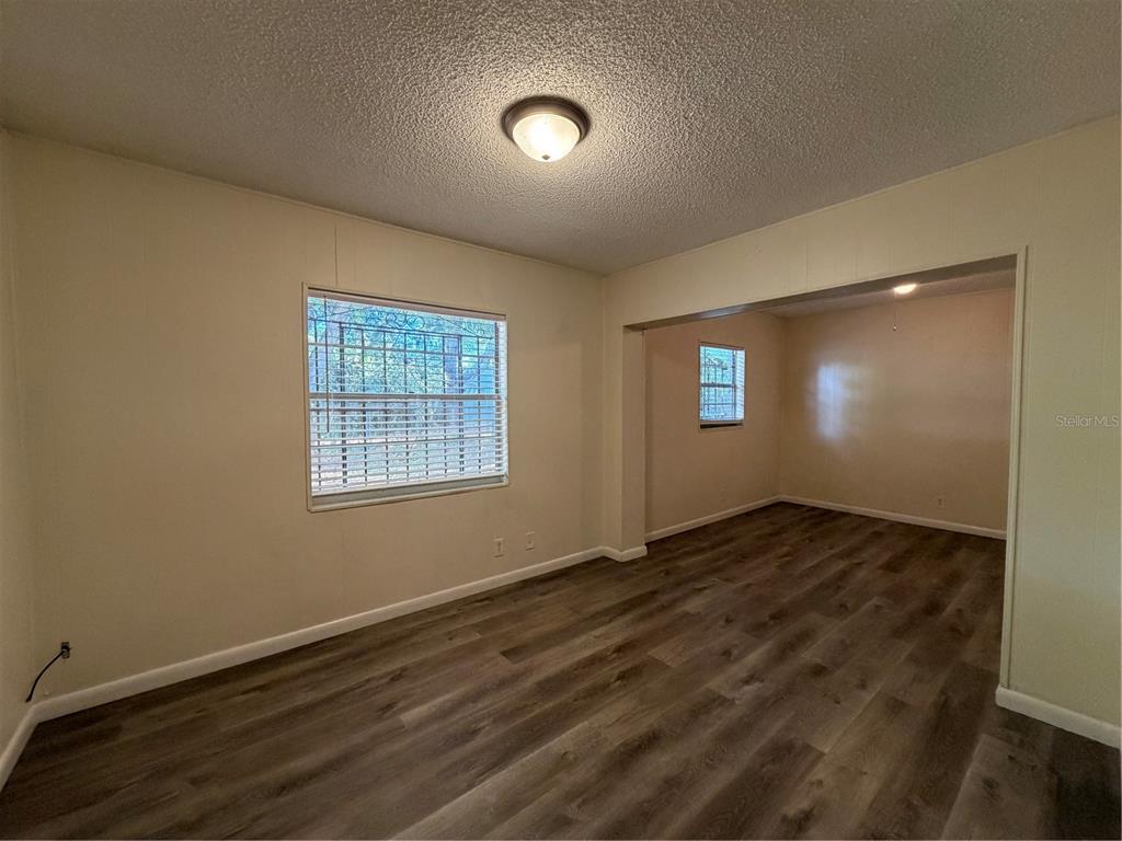 1740 West Walnut Street Tampa, FL 33607 - Photo 22 of 28 a view of an empty room with window and wooden floor