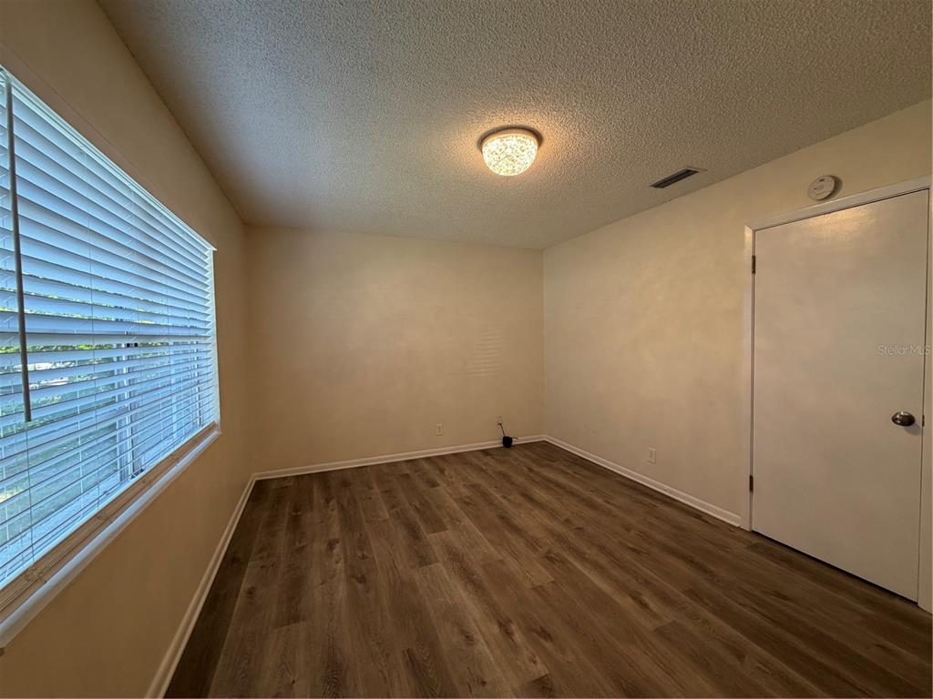 1740 West Walnut Street Tampa, FL 33607 - Photo 4 of 28 a view of a room with wooden floor and window