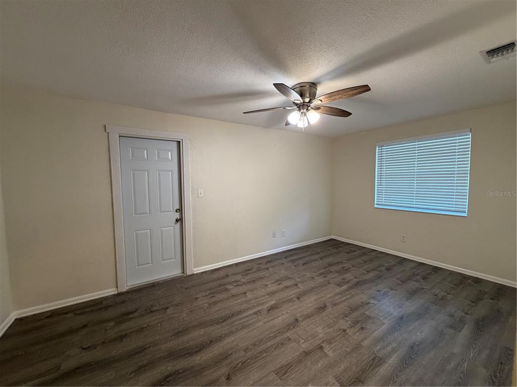1740 West Walnut Street Tampa, FL 33607 - Photo 9 of 28 a view of an empty room with a ceiling fan