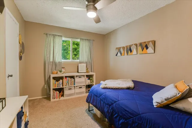 a bedroom with furniture and a book shelf