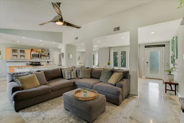 a living room with furniture and a chandelier