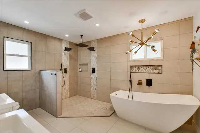 a bathroom with a bathtub and shower