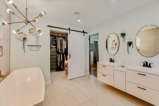 a bathroom with a double vanity sink mirror and shower