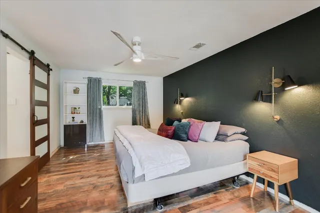 a bedroom with a bed and a flat screen tv