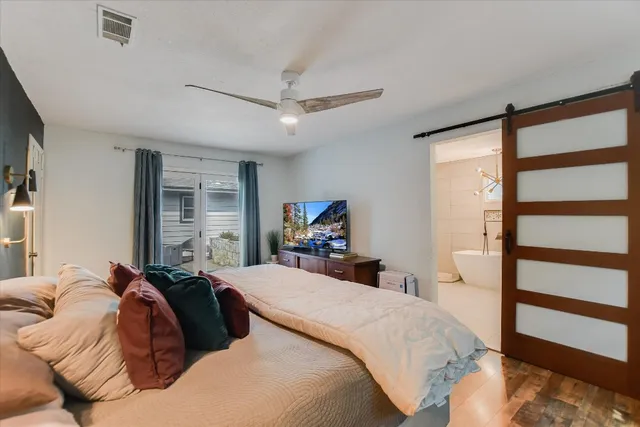 a bed room with a bed and a large mirror