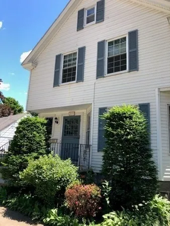 a front view of house with a yard and outdoor seating