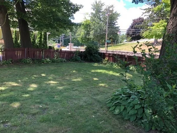 a view of a backyard with swimming pool