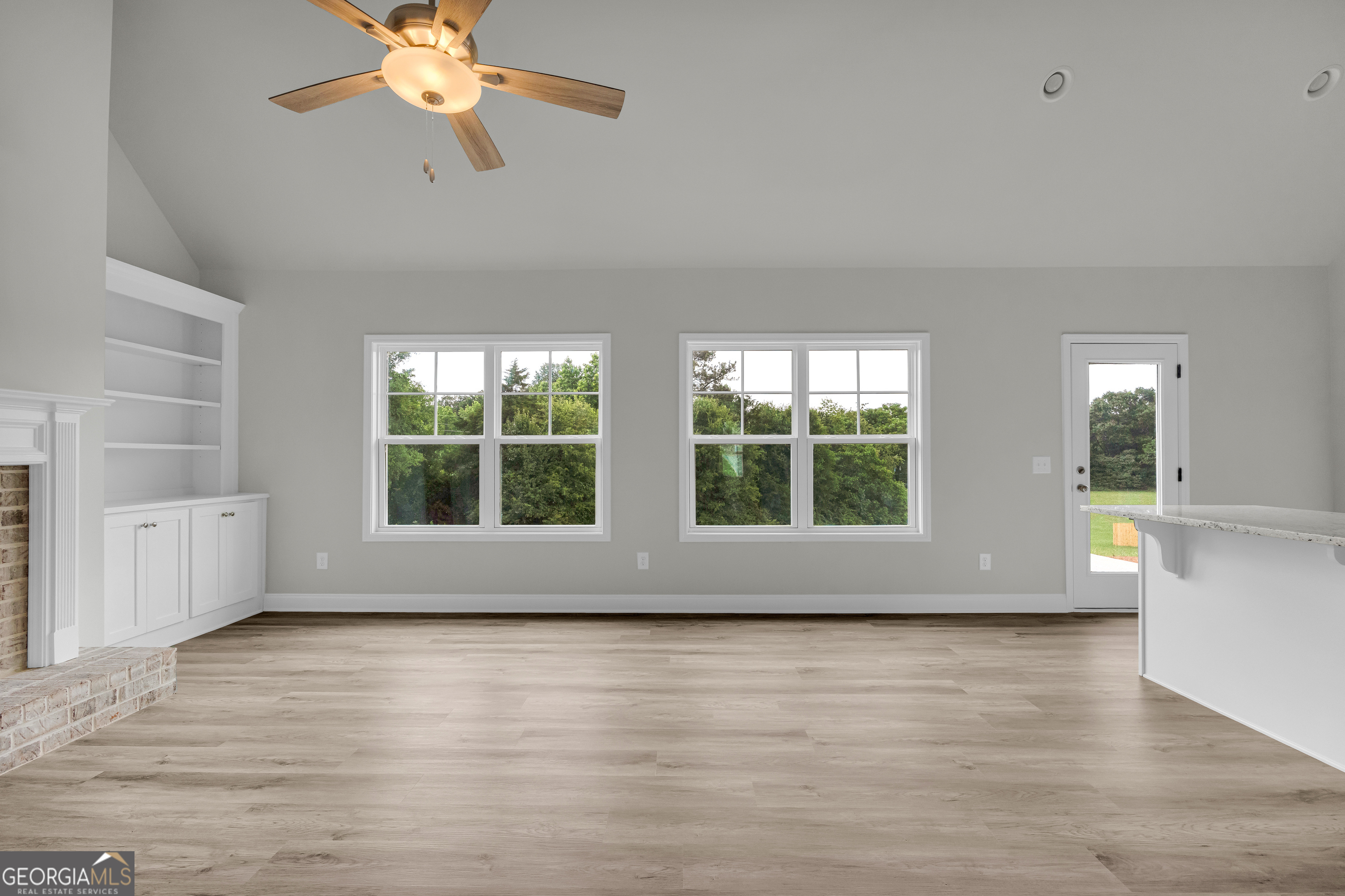 110 Sewell Road Lavonia, GA 30553 - Photo 32 of 73 an empty room with wooden floor and windows
